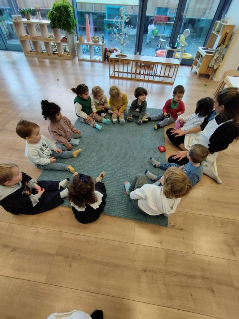 Niños en comunidad infantil Montessori participando en círculo matutino